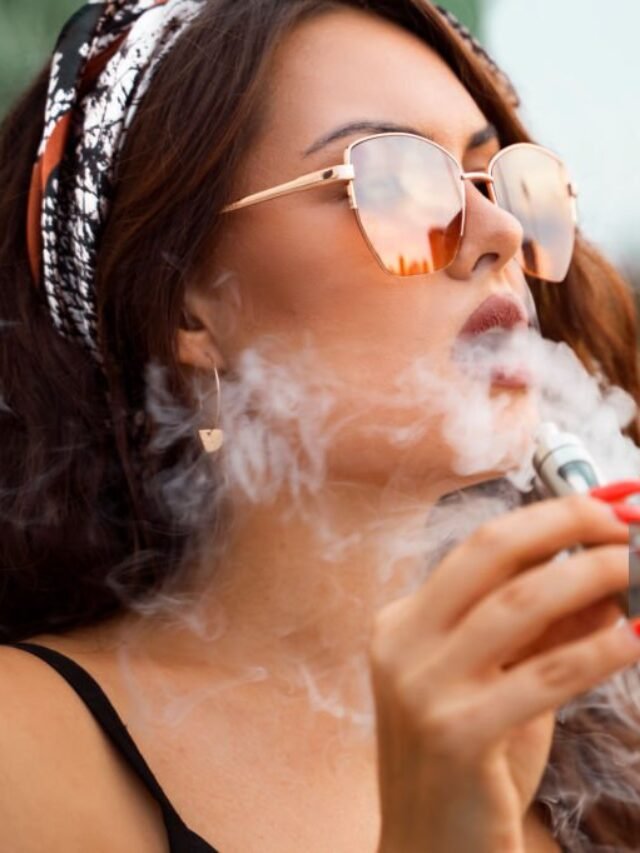 Closeup portrait gorgeous young girl smoking e-cigarette