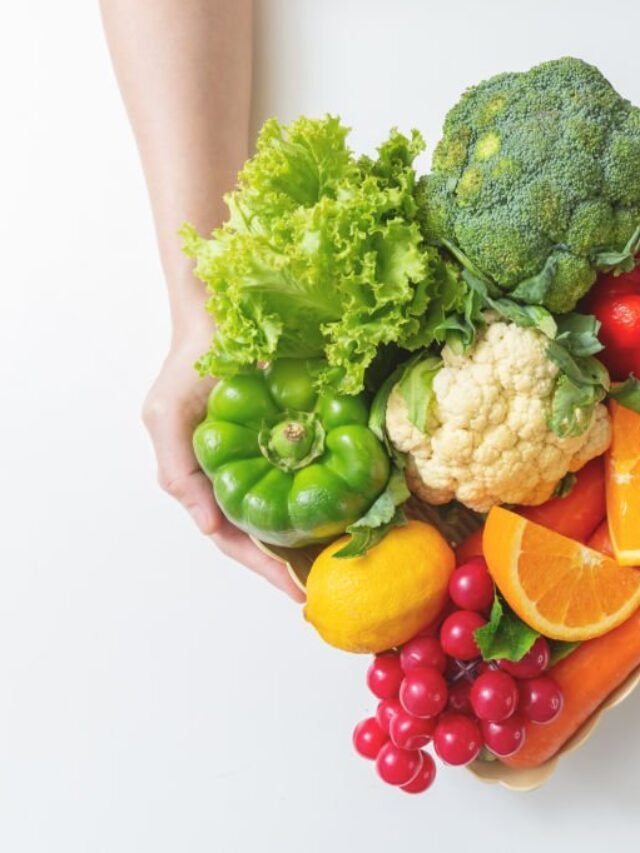 Closeup of hands Woman with fresh vegetables in the box. top view