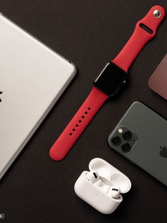 Flat Lay of different apple products on a dark grey background.